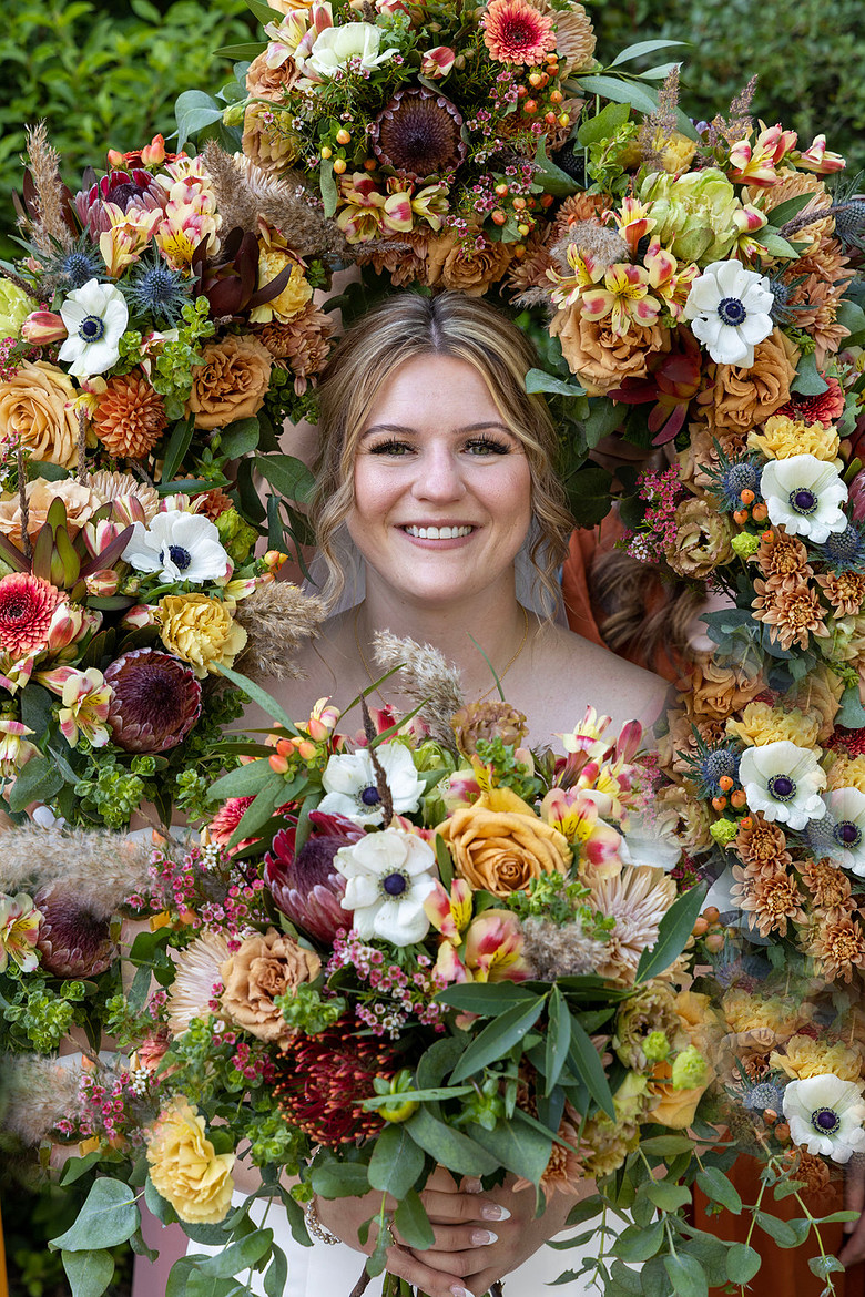 Sacramento Zoo Wedding. Bridesmaid pictures with all bridesmaids holding flowers around bride.