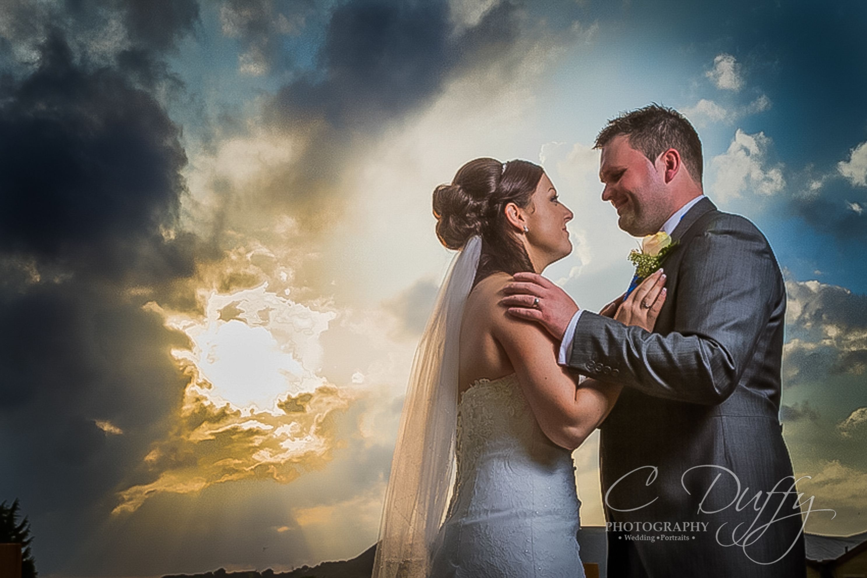 Wild sky bride and groom portrait at The Red Hall Hotel captured by Bury Wedding Photographer