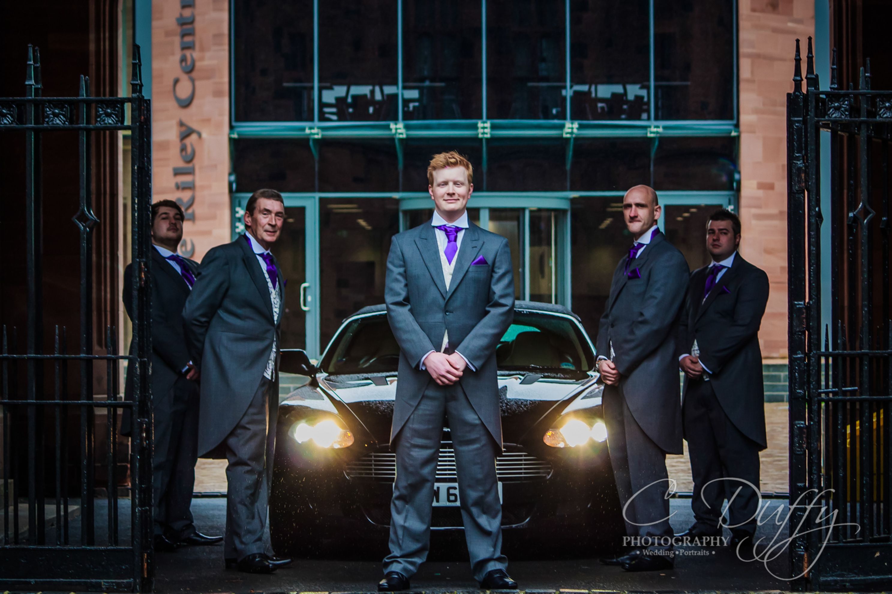 Groomsmen portrait with Aston Martin captured by Bolton School Wedding photographer
