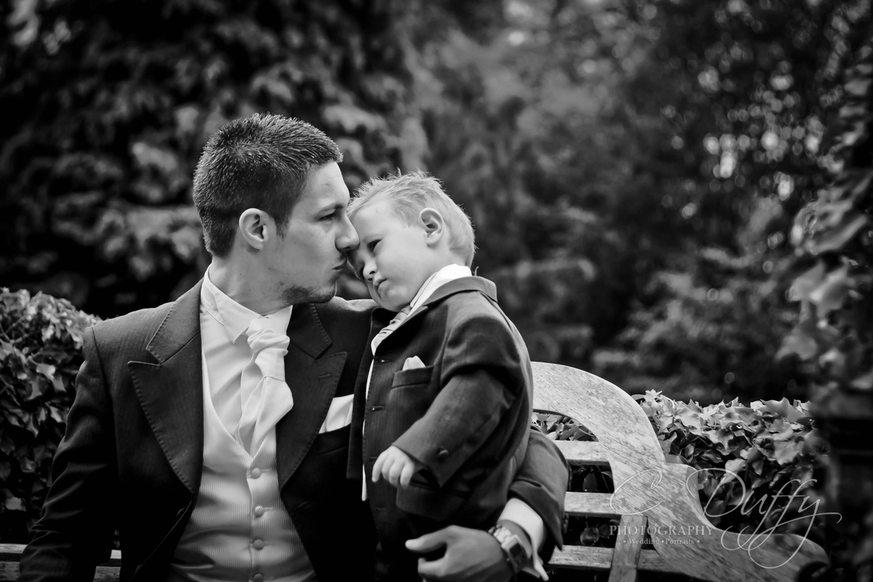 Father and son tender moment at wedding