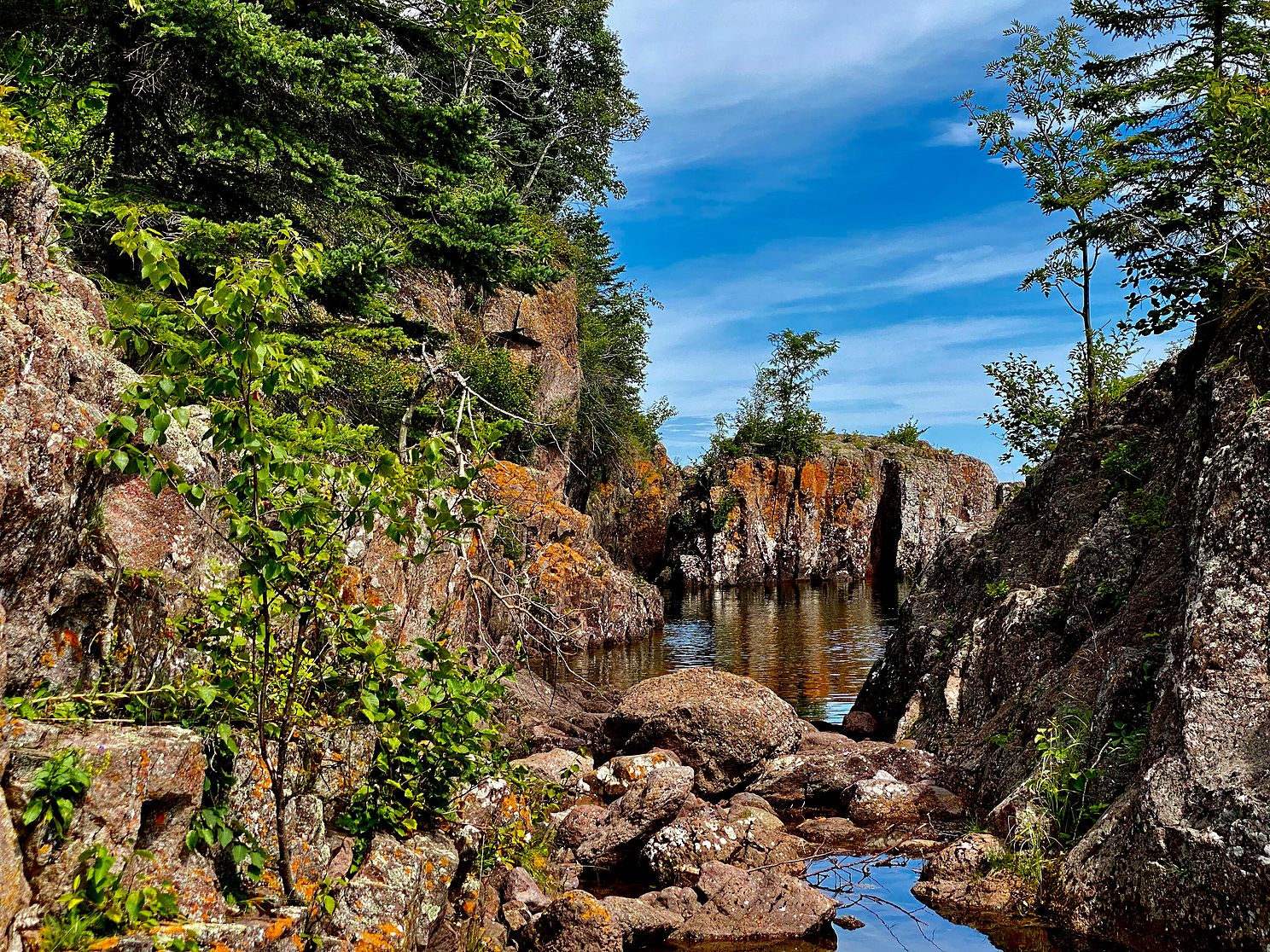 Temperance River flows out into Lake Superior with a shoreline of beautiful rock formations.
