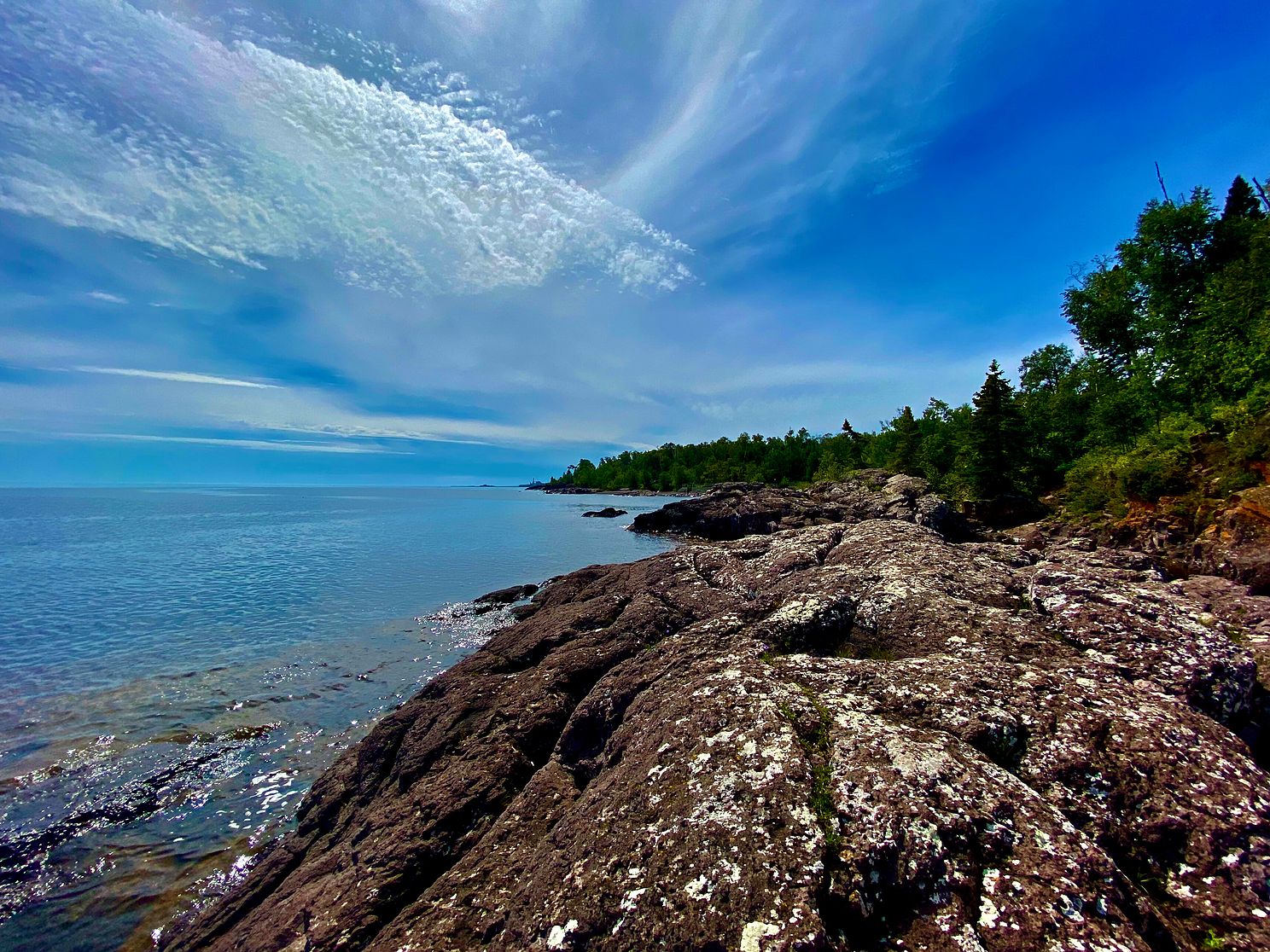 Clouds dance above the shores of Lake Superior. Nature's beauty captured in this photograph.
