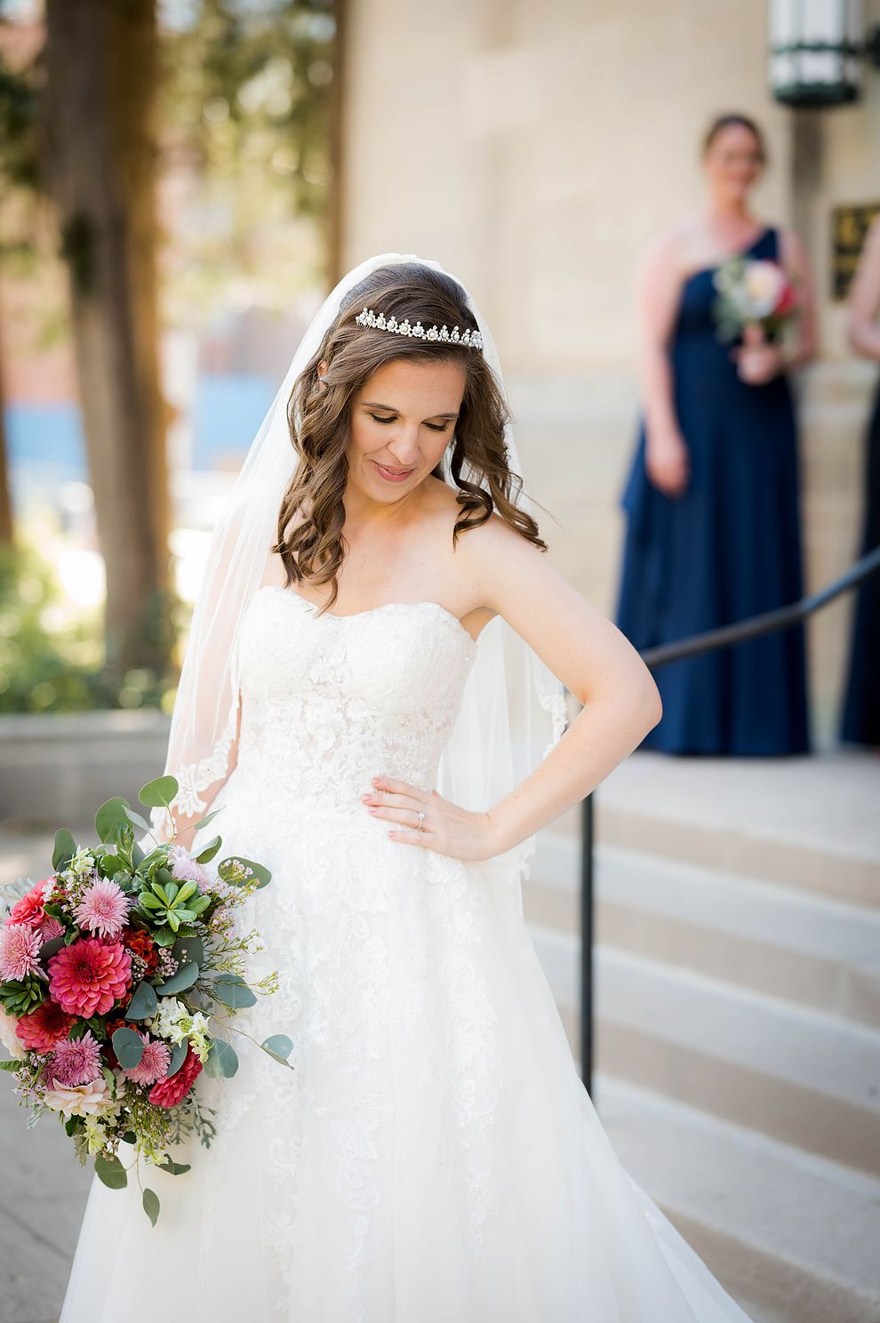 Bride admiring her wedding dress before she walks down the aisle to meet her groom.