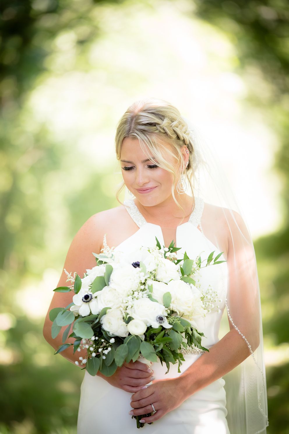 Bride looking at her flowers before walking down the aisle.