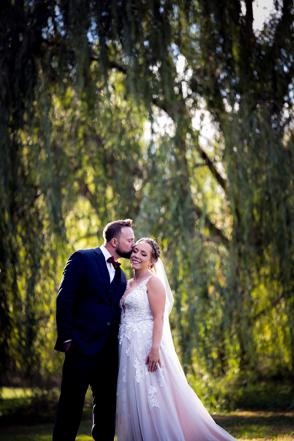 Wedding Photos under a willow tree during golden hour.