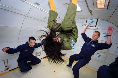 a person doing a flip in a zero gravity plane ride