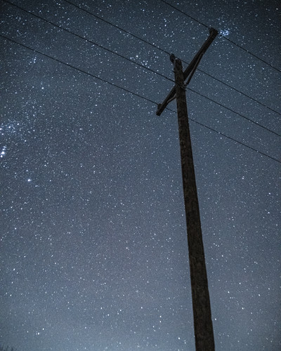 Phone Home  A telephone pole under the night skyjpg