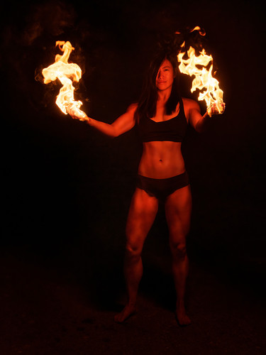a person standing holding fireballs in both hands