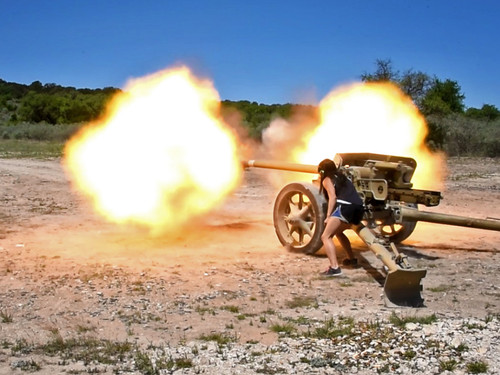 a person firing a german anti tank gun