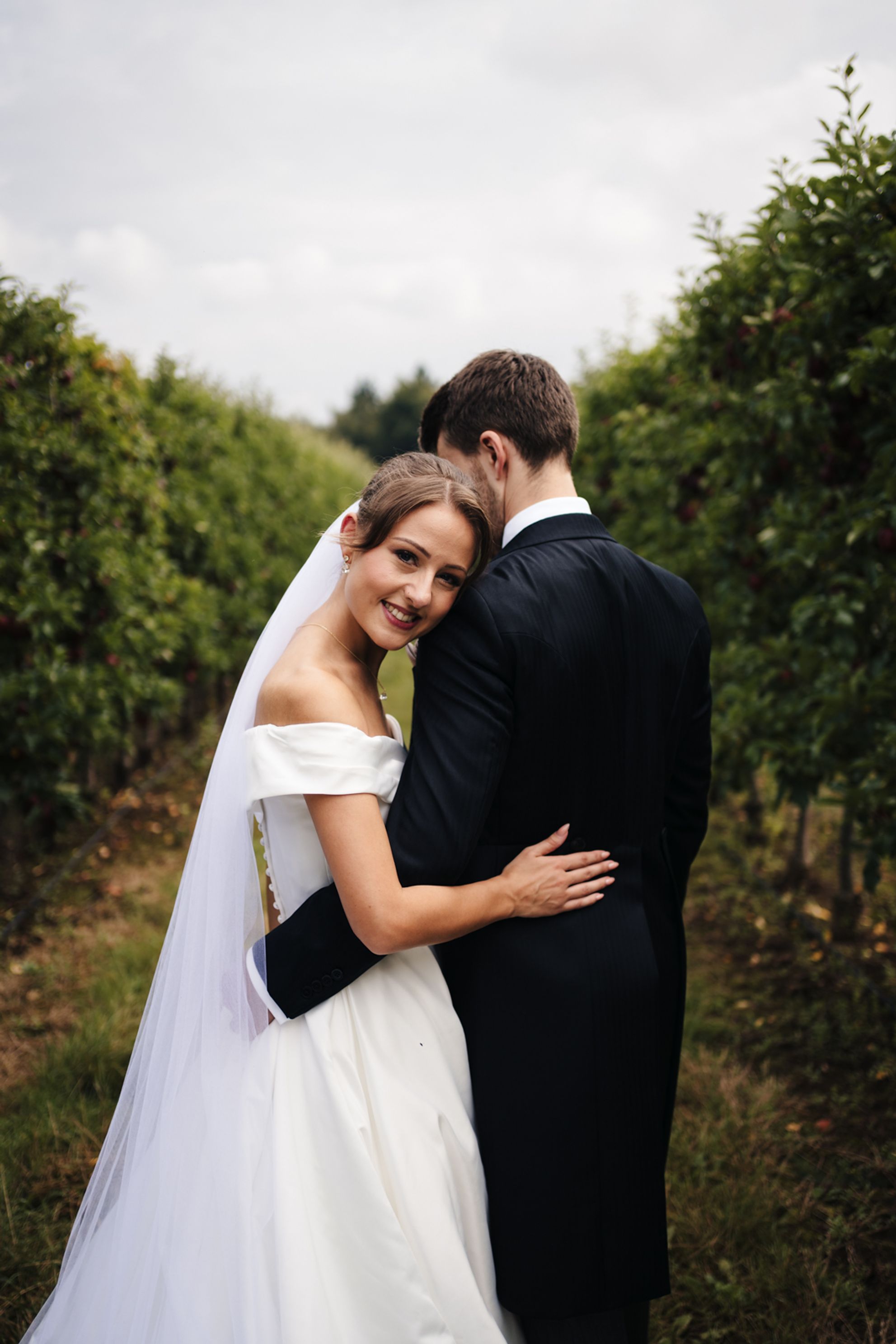 Married couple poses for a romantic portrait in Ross-on-Wye, capturing love and scenic beauty.